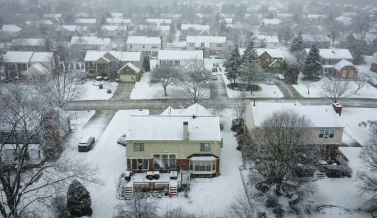 Indianapolis winter exterior damage visible on snow-covered neighborhood homes