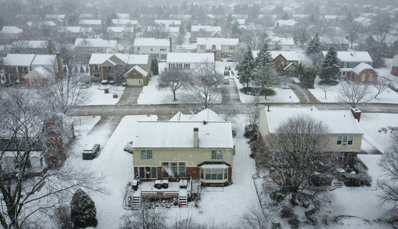 Indianapolis winter exterior damage visible on snow-covered neighborhood homes