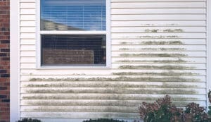 Dirty siding before house exterior cleaning showing mildew and dirt buildup